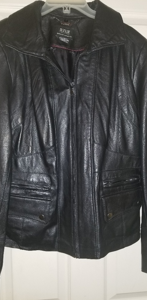 Woman waist length black leather jacket.